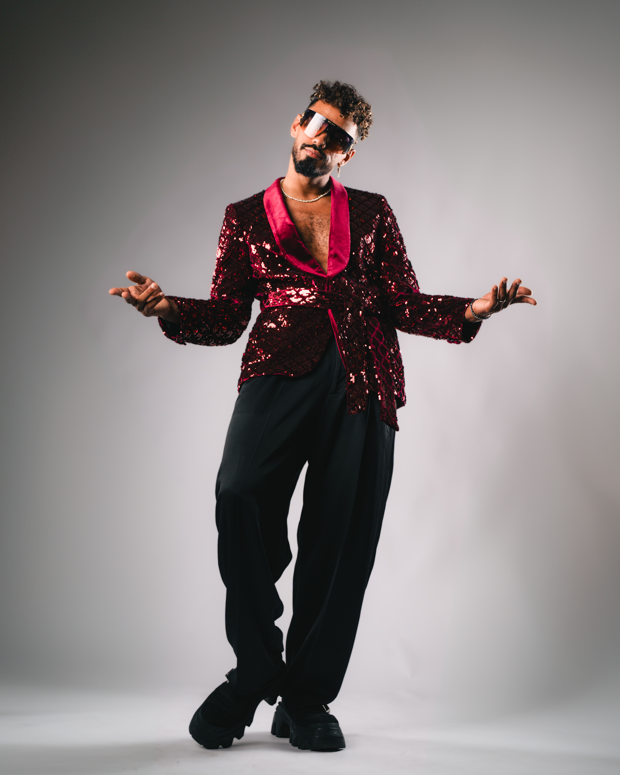 A man in a blue shirt with a happy expression