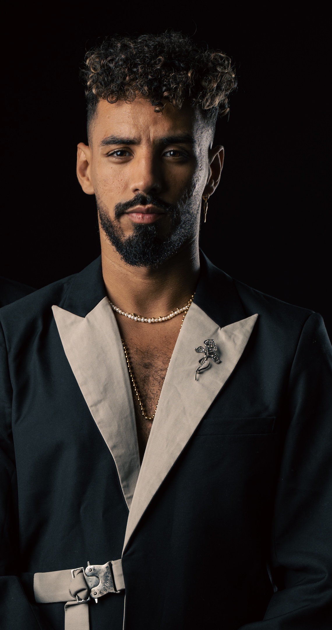 On a yellow background, a digital watch and a glass.
