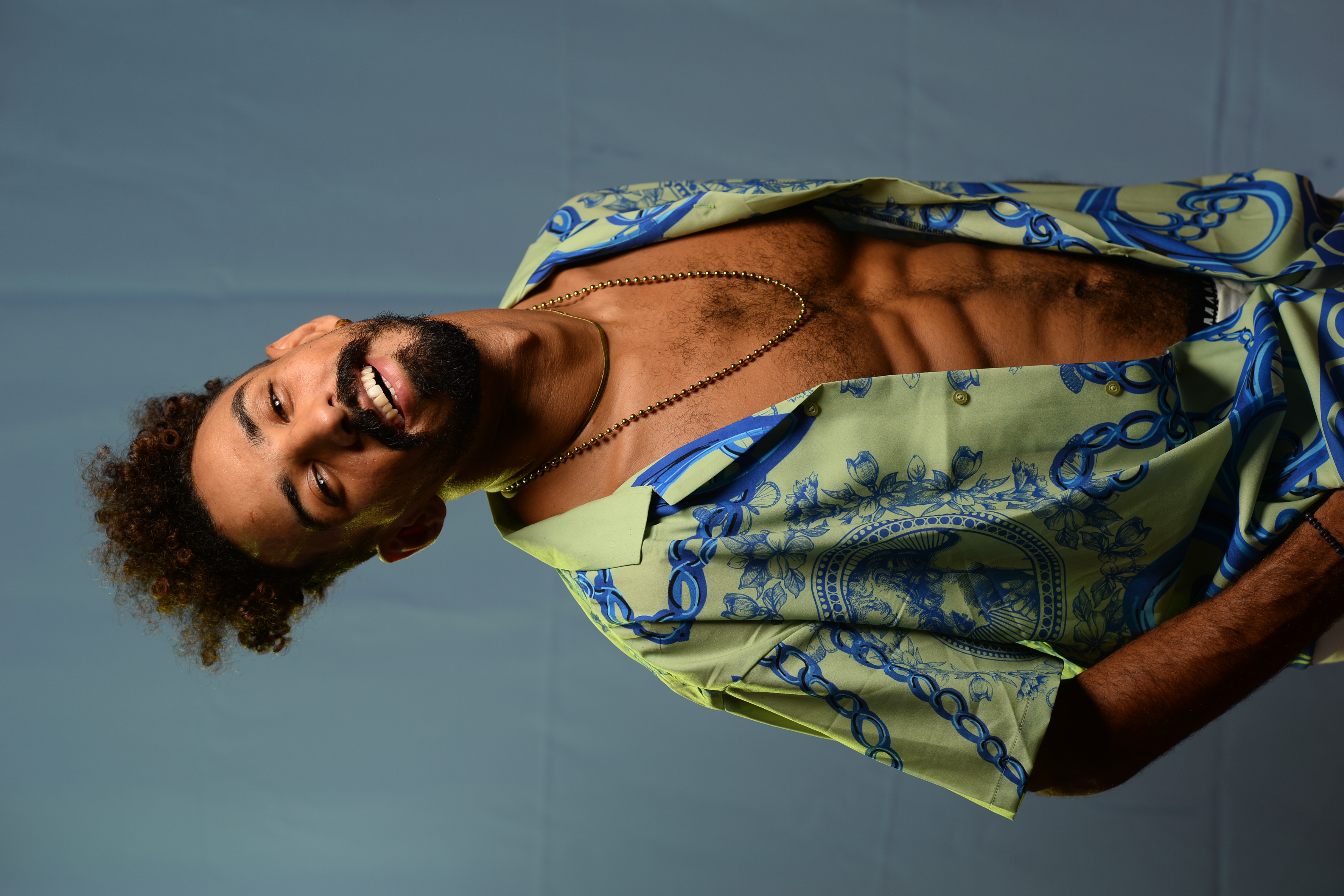 A fujifilm instant camera on a dark electric blue background.